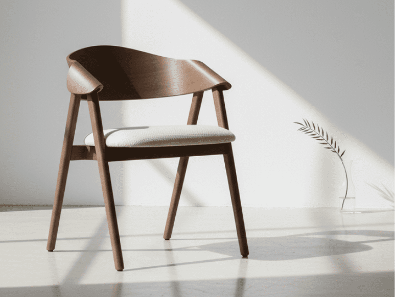 Dina Arm US wood dining chair showcasing a curved solid wood backrest, upholstered comfort, and timeless hospitality design.