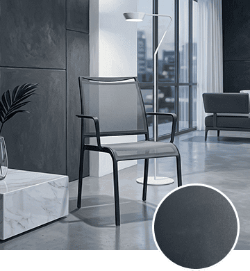 KECA metal chair in a dark charcoal Gray Arsenic powder-coat finish in a loft-style interior, showing an industrial option for commercial seating.