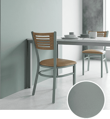 KECA metal chair in a light, soft Mint Gray powder-coat finish in an airy dining space, showing a fresh, modern option for commercial seating.