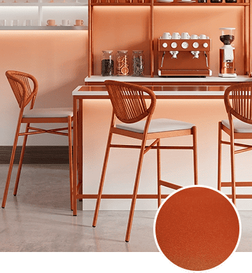 KECA metal chair in a creative, vibrant Orange powder-coat finish warming a cool-toned room, showing an energetic accent option for commercial seating.