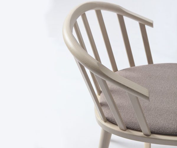 A white chair with a gray cushion on it