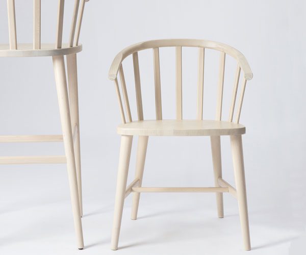 A white chair next to a white chair on a white background
